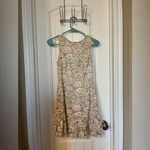 Cream and white flowery dress. Ruffles at the bottom.